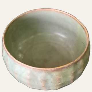 "Medium celadon-glazed ceramic bowl with raised rim ridges resembling water-lily petals.