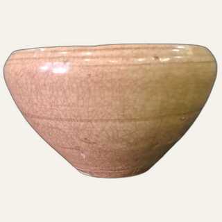 Large yellow-brown glazed ceramic bowl with incised floral motifs