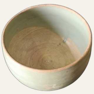 Medium celadon-glazed ceramic bowl with glaze pooling in the interior