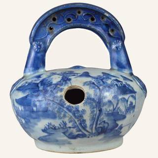 Medium‑sized lime pot with handle, finished in a white glaze and decorated in cobalt blue underglaze with natural landscape motifs